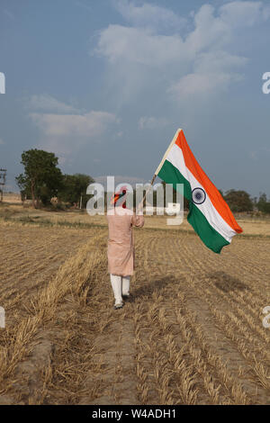 Farmer holding an Indian flag in a field Stock Photo - Alamy