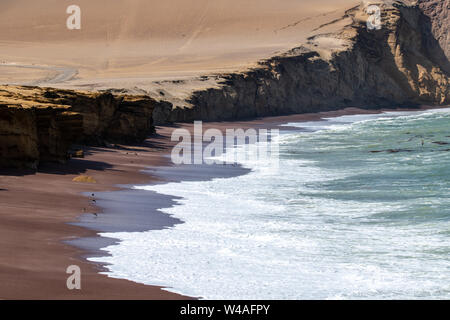 Red sand beach (Playa roja) in Paracas National Reserve in Southern Peru on the Paracas Peninsula Stock Photo