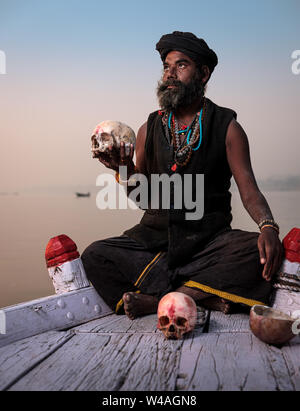 Varanasi, INDIA - CIRCA NOVEMBER 2018: Portrait of a Aghori with skull in Varanasi. The Aghoris are a small group of ascetic Shaiva sadhus. They engag Stock Photo