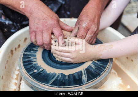 Master class on modeling of clay on a potter's wheel In the pottery workshop Stock Photo