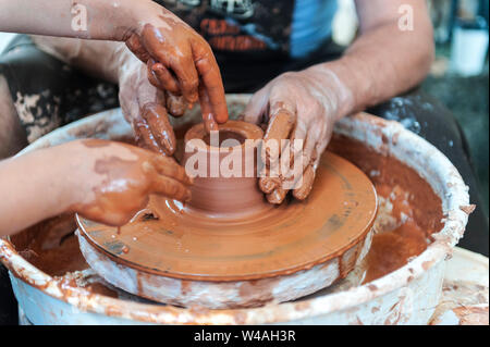 Master class on modeling of clay on a potter's wheel In the pottery workshop Stock Photo
