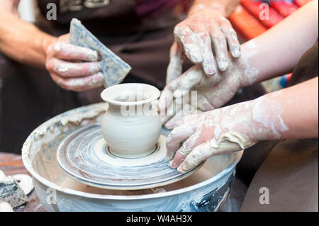 Master class on modeling of clay on a potter's wheel In the pottery workshop Stock Photo