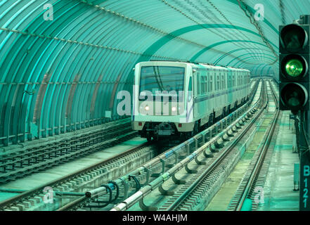 Sofia Metro train old Russian subway underground metro train model 81-740/741 'Rusich' approaching station. Subway underground railway metro tracks lines on the approach of a station passing under green curved polypropylene frame in bright tunnel. Urban transport concept. Green block colour or block color. Sofia, Bulgaria, EU Stock Photo