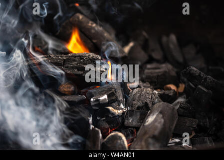 the burning black coals for a barbecue in a brazier a close-up view Stock Photo