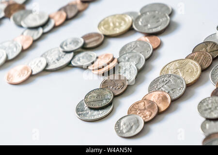 Coins isolated on solid white background spelling the word Money from loose coin change. Blank empty room space for text or copy. Financial mockup con Stock Photo