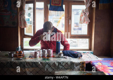 Man drinking tea in village town in Himalayan Mountains Stock Photo