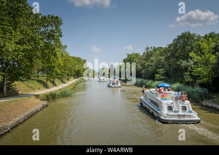 A pleasure motor boat cruising along the Canal du Midi, France on a sunny day in summer Stock Photo