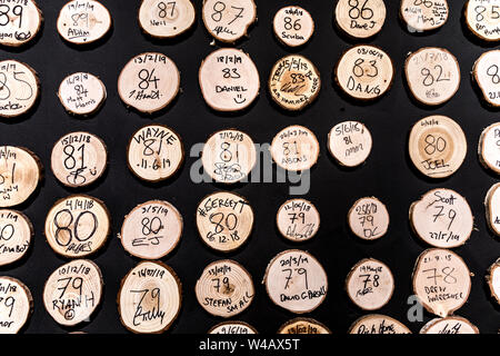 Tree slices with high scores on the wall at Whistle Punks Urban Axe Throwing, London, UK Stock Photo