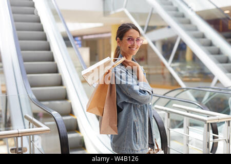 Premium Photo | African woman bloger posed in sweater and jeans posed at  mall with her mobile phone