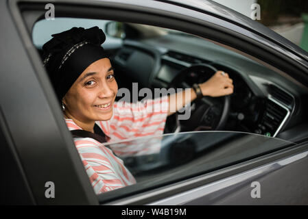 Asian woman driving car