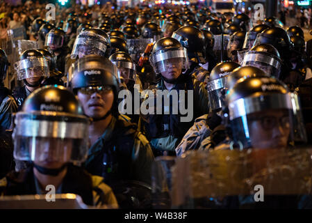 Riot police officers stand on guard during the clashes with protesters following a march against a controversial extradition bill in Hong Kong. Stock Photo