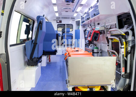 Inside an ambulance car with medical equipment for helping patients before delivery to the hospital. Stock Photo
