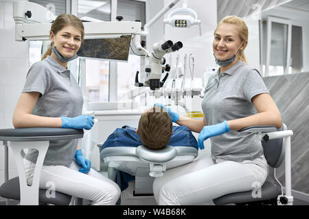 Cheerful dentists posing on camera during their work Stock Photo