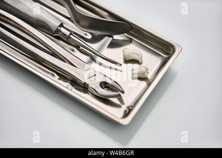 Dental instruments lying in chrome medical tray Stock Photo