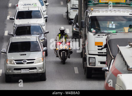 Bangkok, Thailand - May 28, 2018: Police motorbike manouvering through a traffic jam on Kanchana Phisek Road, the ring road around Bangkok, at Talat B Stock Photo