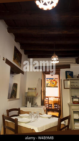 Interior of a typical Sicilian restaurant, with original paintings on the wall, Ortigia, Siracusa, Sicily, Italy Stock Photo