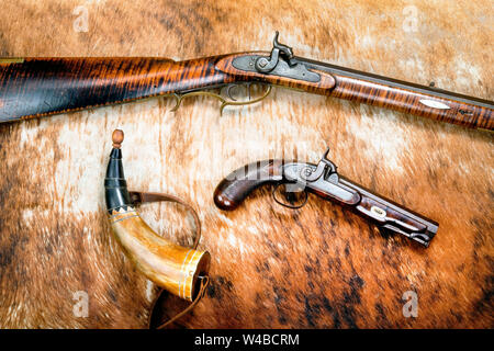 Antique procussion cap and ball rifle,pistol and gunpowder horn made around 1840. Stock Photo