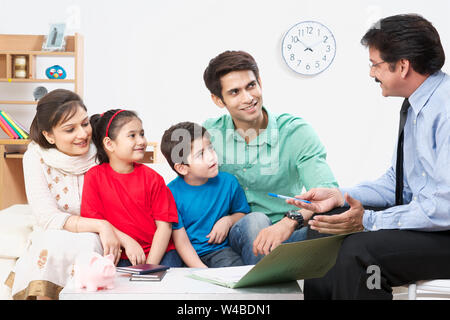 Executive explaining insurance plan to a family Stock Photo