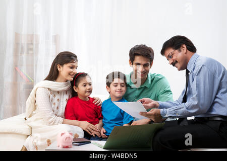 Executive explaining insurance plan to a family Stock Photo