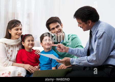 Executive explaining insurance plan to a family Stock Photo