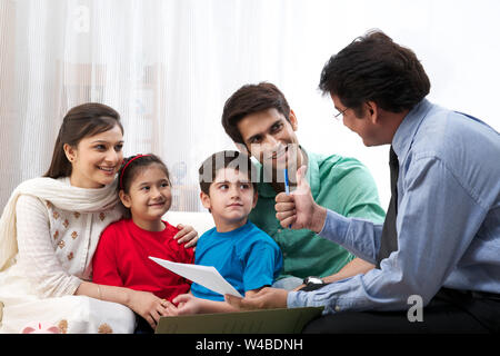 Executive explaining insurance plan to a family Stock Photo