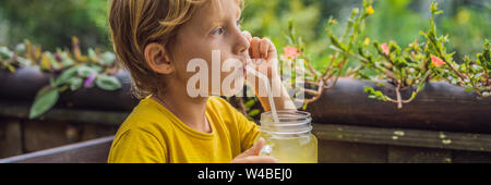 Boy drinking juice in a cafe. What to do with children. Child friendly place BANNER, LONG FORMAT Stock Photo