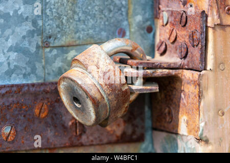 Padlock on the door. Rusty gate Close up Stock Photo