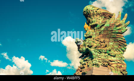 Landscape picture of tallest Garuda Wisnu Kencana GWK statue as Bali landmark with blue sky as a background. Stock Photo