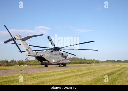 A CH-53E Super Stallion prepares to take off at the Eastport Municipal Airport (EPM), piloted by Maj. Grant Covey and Capt. Jonathon Barnes, both CH-53E pilots assigned to Marine Heavy Helicopter Squadron (HMH) 461, Eastport, Maine, July 17, 2019. Covey and Barnes landed at EPM for tactical approach training on their flight line. EPM is the furthest eastern airport in the United States, directly next to the border of Canada. (U.S. Marine Corps photo by Cpl. Micha Pierce) Stock Photo