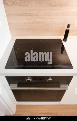 Electric stove with induction cooktop in contemporary kitchen Stock Photo