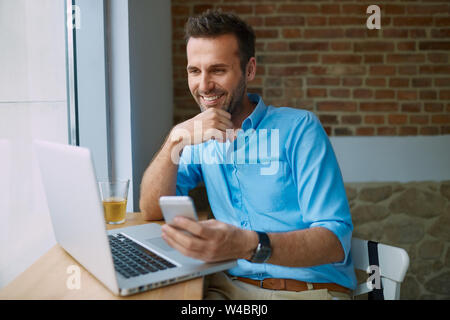 Young man paying for online shopping with smartphone Stock Photo