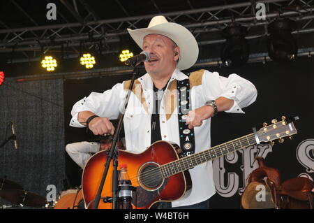 16 July 2019, Schleswig-Holstein, Heiligenhafen: TRUCK STOP - The Country Band from Waterkant on 16 July 2019 in Heiligenhafen at the Heiligenhafener Hafenfesttage (For the 44th time from 11 July to 21 July 2019) open air stage appearance dierkt at the harbour basin. From 20 - 22 o'clock there was Country Rock and songs from the brand new album 'Ein Stückchen Ewigkeit' for over two thousand guests of the event. Schleswig-Holstein, Germany, Europe. Photo: Holger Kasnitz/dpa Stock Photo