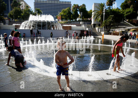 Los Angeles, USA. 21st July, 2019. Children cool off in a fountain in Los Angeles, the United States, July 21, 2019. Credit: Li Ying/Xinhua/Alamy Live News Stock Photo