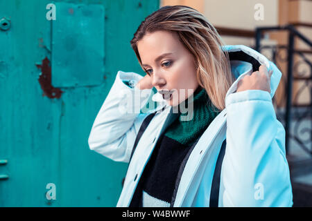 Blonde model with dark lipstick posing in winter jacket Stock Photo