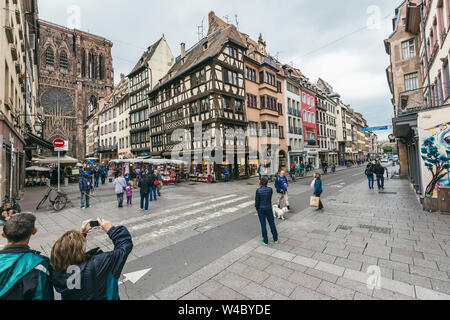 Strasbourg, France - July 26, 2017. Tourists walk along the street of Strasbourg near the cathedral Stock Photo