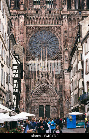 Strasbourg, France - July 26, 2017. Tourists walk along the street of Strasbourg near the cathedral Stock Photo