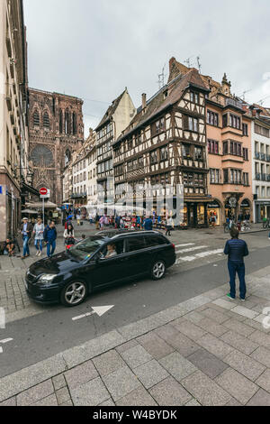 Strasbourg, France - July 26, 2017. Tourists walk along the street of Strasbourg near the cathedral Stock Photo