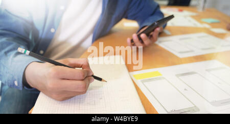 Young male designer working on website UX app development, Close-up view Stock Photo