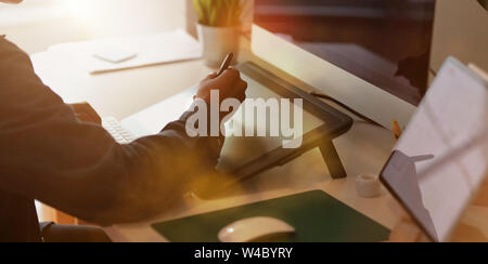 Close-up view of young UI developer's hand working in his office room Stock Photo