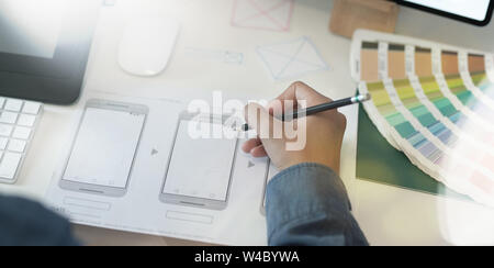 Close-up of UI UX graphic designer drawing smartphone template for his new project Stock Photo