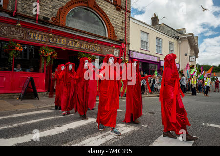 Editorial: Truro, Cornwall, UK. 20/07/2019. Extinction Rebellions art troupe The Red Rebellion parade through the streets of Truro in Cornwall. Stock Photo