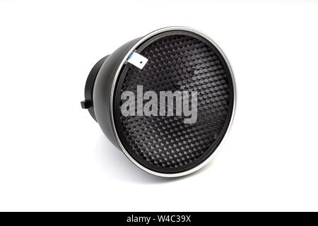 Reflector with honeycomb grid accessory for studio strobes and flashes on white background. Selective focus Stock Photo