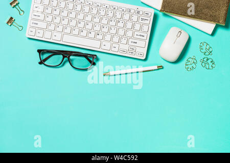 Office workplace with keyboard, notepad, glasses and pen Stock Photo