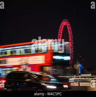 Blurred movement of a London Bus travelling over Waterloo Bridge at night, London England UK Stock Photo