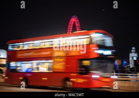 Blurred movement of a London Bus travelling over Waterloo Bridge at night, London England UK Stock Photo