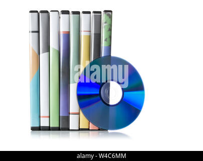 DVD, CD-ROM or Blu-Ray disc with stacked boxes for movies, audio or software on white background Stock Photo