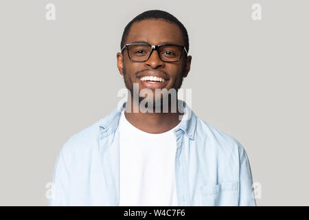 Portrait of smiling black man in glasses isolated in studio Stock Photo