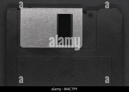 Part of black floppy disk with copy space on black grunge background Stock Photo