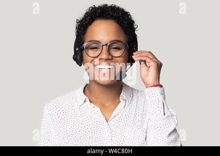 Portrait of smiling biracial female call center agent in headset Stock Photo