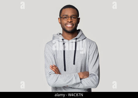 Smiling black male in glasses stand with arms crossed Stock Photo